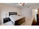 Bedroom with carpet, ceiling fan, wooden bed frame, side tables, and neutral walls at 7701 W Robindale Rd # 206, Las Vegas, NV 89113