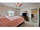 Cozy bedroom with ceiling fan, dresser with flat screen television, and a comfortable bed at 7701 W Robindale Rd # 206, Las Vegas, NV 89113