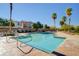 Beautiful community pool area with inviting lounge chairs and lush palm trees at 7701 W Robindale Rd # 206, Las Vegas, NV 89113