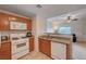 Well-equipped kitchen with white appliances, including a dishwasher and microwave, offering functionality and style at 7701 W Robindale Rd # 206, Las Vegas, NV 89113