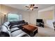 Inviting living room with plush seating, ceiling fan, and large window offering pleasant view and natural light at 7701 W Robindale Rd # 206, Las Vegas, NV 89113
