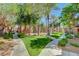 Charming neighborhood with lush landscaping, sidewalks, and well-maintained lawns at 7701 W Robindale Rd # 206, Las Vegas, NV 89113