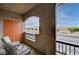 Cozy patio features two chairs, small table, and offers pleasant views of the neighborhood street at 7701 W Robindale Rd # 206, Las Vegas, NV 89113