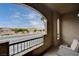 Exterior shot from patio showing neighborhood street views, arched windows and wrought iron railing at 7701 W Robindale Rd # 206, Las Vegas, NV 89113
