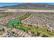 Aerial view of a community with a golf course, lakes, and desert landscaping at 7720 Fruit Dove St, North Las Vegas, NV 89084