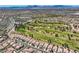 Aerial view of a community with a golf course and mountain views at 7720 Fruit Dove St, North Las Vegas, NV 89084