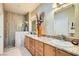 Well-lit bathroom features double sinks, a granite countertop, and a tiled walk-in shower at 7720 Fruit Dove St, North Las Vegas, NV 89084
