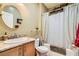 Bathroom features a decorative mirror, single sink vanity, and shower-tub combo at 7720 Fruit Dove St, North Las Vegas, NV 89084