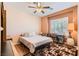 Bedroom features a comfortable bed, desk, and decorative area rug at 7720 Fruit Dove St, North Las Vegas, NV 89084