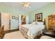 Bright bedroom with a ceiling fan, shutters, and a comfortable queen-sized bed at 7720 Fruit Dove St, North Las Vegas, NV 89084