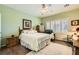 Bright bedroom with a ceiling fan, shutters, and a comfortable queen-sized bed at 7720 Fruit Dove St, North Las Vegas, NV 89084