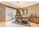 Cozy dining area features a view of the backyard, comfortable seating, and ample natural light at 7720 Fruit Dove St, North Las Vegas, NV 89084