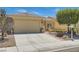 Charming single-story home with a well-manicured lawn and a two-car garage at 7720 Fruit Dove St, North Las Vegas, NV 89084
