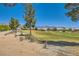 Beautiful golf course view with mature trees and desert landscaping in the surrounding area at 7720 Fruit Dove St, North Las Vegas, NV 89084