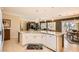 Open kitchen with granite countertops, island with seating, and seamlessly flows into the living area at 7720 Fruit Dove St, North Las Vegas, NV 89084