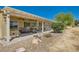 Inviting covered patio with a ceiling fan, sitting area, and views of the yard at 7720 Fruit Dove St, North Las Vegas, NV 89084