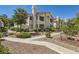 Inviting condo featuring well-maintained landscaping and a charming two-story facade under a clear blue sky at 7900 Ryandale Cir # 201, Las Vegas, NV 89145