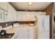 Well-lit kitchen featuring white cabinets, a microwave, a gas stove, and a refrigerator at 7900 Ryandale Cir # 201, Las Vegas, NV 89145