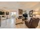 Open living space with tile flooring, comfortable seating, and a view of the balcony through sliding doors at 7900 Ryandale Cir # 201, Las Vegas, NV 89145