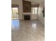Bright living room featuring neutral tile, fireplace, and sliding glass door to the balcony at 7900 Ryandale Cir # 201, Las Vegas, NV 89145