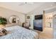 Spacious bedroom with a mirrored dresser, walk-in closet, and convenient laundry access at 7900 Ryandale Cir # 201, Las Vegas, NV 89145