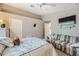 This primary bedroom has an interior design with a sofa, a queen bed and mounted television at 7900 Ryandale Cir # 201, Las Vegas, NV 89145