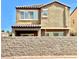 Two-story home with a stucco and tile roof, a covered patio, and a block wall in the back at 81 Sertata Ct, Henderson, NV 89074