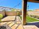 A backyard features desert landscaping, a stone pathway, string lights, and block perimeter wall at 81 Sertata Ct, Henderson, NV 89074
