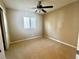 Neutral bedroom with a ceiling fan and window with shutters at 81 Sertata Ct, Henderson, NV 89074