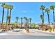 Community entrance with palm trees, well-maintained greenery and manicured common areas at 81 Sertata Ct, Henderson, NV 89074