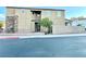 Two-story house featuring stucco exterior, stone accents, iron fence, and landscaping at 81 Sertata Ct, Henderson, NV 89074