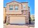 Two-story home showcasing a brick driveway, stone accents, and a two-car garage at 81 Sertata Ct, Henderson, NV 89074