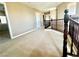 Spacious hallway features neutral carpet, paneled doors and dark wood railing at 81 Sertata Ct, Henderson, NV 89074