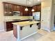 Bright kitchen with stainless steel appliances, granite countertops, and a center island with a sink at 81 Sertata Ct, Henderson, NV 89074