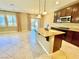 Open kitchen featuring granite counters, stainless appliances, island with seating, and adjacent living area at 81 Sertata Ct, Henderson, NV 89074