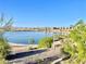 View of the lake with walking path surrounded by trees and desert vegetation at 81 Sertata Ct, Henderson, NV 89074