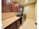 Spacious laundry room with dark cabinetry and modern washer and dryer units at 81 Sertata Ct, Henderson, NV 89074