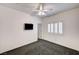Comfortable bedroom featuring neutral walls, carpet, ceiling fan, shuttered window, and TV at 900 Royal Plum Ln, Las Vegas, NV 89144
