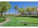Well-manicured front lawn with mature trees and lush landscaping in a serene neighborhood setting at 900 Royal Plum Ln, Las Vegas, NV 89144