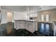 Open concept kitchen with island, stainless steel appliances, and granite counters with a view of the living room at 900 Royal Plum Ln, Las Vegas, NV 89144