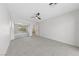 Bright bedroom featuring neutral carpet, ceiling fan, and mirrored closet doors at 10617 Tuckermans Ave, Las Vegas, NV 89129