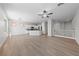 Spacious living room with wood floors, fan, and abundant natural light at 10617 Tuckermans Ave, Las Vegas, NV 89129