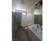 Cozy bathroom with shower-tub combination, single sink vanity and neutral tile floor at 1144 Black Cherry St, Las Vegas, NV 89142