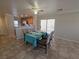 Dining area features tile flooring, set table, and sliding glass door leading to outdoor space at 1144 Black Cherry St, Las Vegas, NV 89142