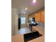 Well-lit kitchen featuring wooden cabinets, laminate countertops, and modern stainless steel appliances at 1144 Black Cherry St, Las Vegas, NV 89142