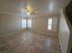 Bright living room with large windows, tiled floor, and ceiling fan at 1144 Black Cherry St, Las Vegas, NV 89142
