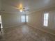 Bright living room with large windows, tiled floor, and ceiling fan at 1144 Black Cherry St, Las Vegas, NV 89142