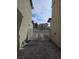 Concrete side yard featuring gated access to the front, providing a secure and private outdoor area between homes at 1144 Black Cherry St, Las Vegas, NV 89142