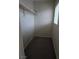 A simple, yet spacious walk-in closet features neutral walls and includes a rack and shelf for easy organization at 1144 Black Cherry St, Las Vegas, NV 89142