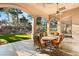 Covered back patio with comfortable seating area, perfect for outdoor dining and entertaining with lush backyard views at 1234 Campbell Dr, Las Vegas, NV 89102